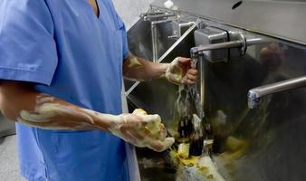 Surgeon preparing for surgery by washing hands and arms photo