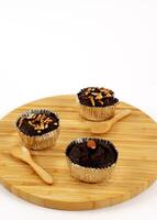 Chocolate brownie on wood plate with wooden spoon on white backgrounds photo