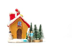 Miniature people celebrating Christmas at home photo