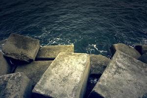 Cement dike in the sea photo