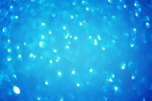 Blue soft defocus light as a texture for designers. Glitter defocus. photo