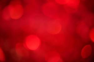 Defocus light on red with black background. The fabric with sequins is out of focus. photo