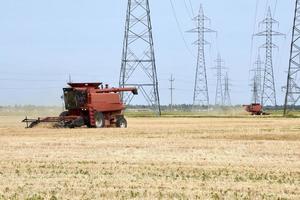 two combines work around hydro towers photo