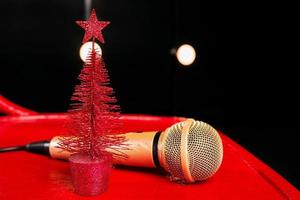 gold microphone on red wooden and dark backgrounds with many lights photo