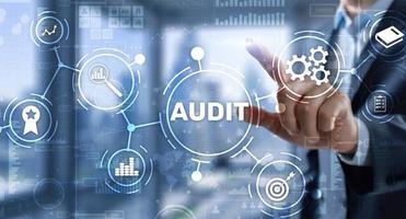 Audit. Checking the financial statements of the company. Businessman touching Audit on 3d virtual screen photo