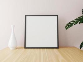 Black square frame mockup on wooden table with vase and plants. 3d rendering. photo