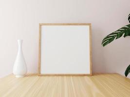 Square wooden frame mockup on wooden table with vase and plants. 3d rendering. photo