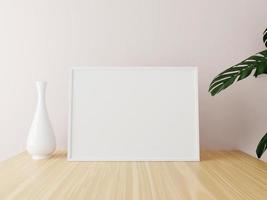 White horizontal frame mockup on wooden table with vase and plants. 3d rendering. photo