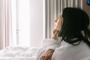 woman in bed thoughtful photo