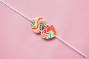 rainbow heart shape candy on pink photo