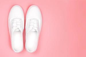White sneakers on a pink background photo