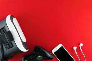 game pad and phone on a red background photo