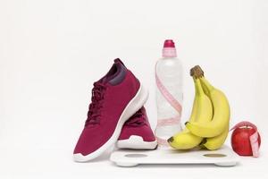 Sports equipment, apple and scales a bottle
