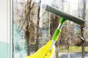 Cleaning windows with a special scraper photo