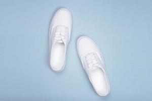 White sneakers on a blue background photo