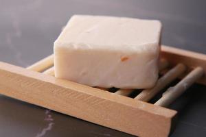 Homemade natural soap bar on black background photo