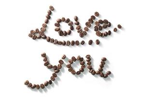 coffee bean lettering close-up top view on white background. brown arabica coffee beans photo