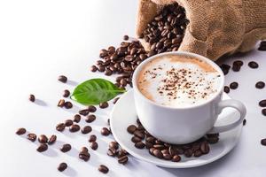 Cup of coffee latte and coffee beans isolated on white background photo