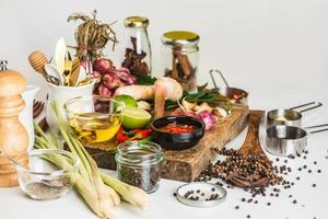 Spices for use as cooking ingredients on a wooden background with Fresh vegetables. Health Food Ingredients - herbs photo