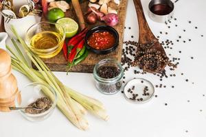 Spices for use as cooking ingredients on a wooden background with Fresh vegetables. Healthy food herbs. Organic vegetables on the table. Raw materials of cooking preparation Tom Yum. photo