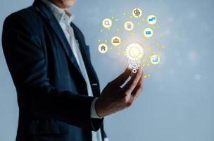 Businessman holding a bright light bulb. photo