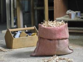 Vintage red bag with sawdust and carpentry tools photo