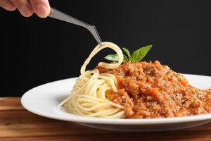 Food stylist use tweezers decorating Italian food photo