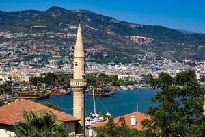 Photo of the minaret, against the background of the city of Alanya.