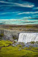 View over biggest and most powerful waterfall in Europe called Dettifoss in Iceland, near lake Myvatn, at blue sky, summer photo