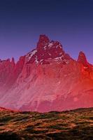 Magical colorful sunrise at major peaks, standing high towers teeth, and waterfall nearby surrounded by wet austral forests in Torres del Paine National Park, Patagonia, Chile, details