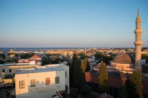 Beautiful aerialv iew of Rhodes old town and harbour just before sunset. Suleiman Mosque wand tower. Greece. photo