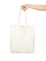 Hand holding canvas tote bag mockup used as design template, isolated on white background with clipping path photo