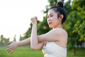 image of asian woman doing yoga outdoors photo