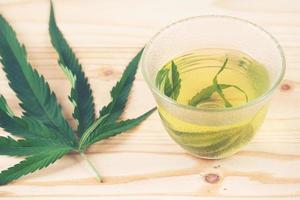 marijuana herbal tea in glass teacup photo