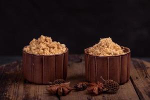 The refined meat floss is in the cup in the dark background photo