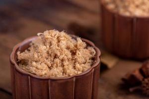 The refined meat floss is in the cup in the dark background photo