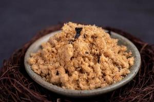 Refined fish floss in a cup against a dark background photo