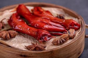 Stewed chicken feet are in the container in the dark background photo