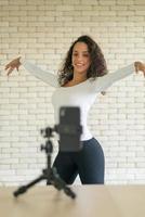 Latin woman created her dancing video by smartphone camera. To share video to social media application. photo