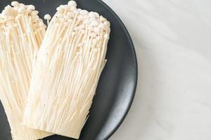 fresh enoki mushroom or golden needle mushrooms photo