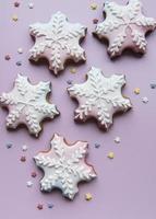 Christmas gingerbread cookies on pink background photo