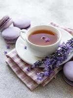 Cup of tea with macaroon dessert with lavender flavor photo