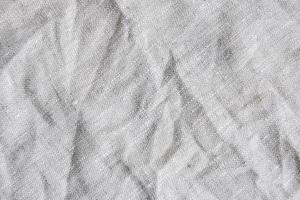 Gray textile linen tablecloth in full frame. photo