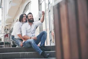 A beautiful couple makes a photo outdoors