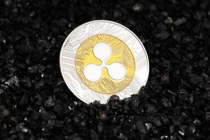 Ripple XRP coin on black gravel background. Cryptocurrency blockchain money photo