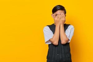 handsome young man covers one eye with palm as if his eye is being tested during vision check photo