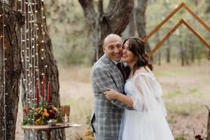 man and woman got engaged in autumn forest photo