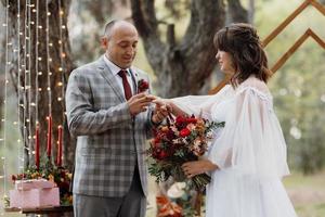 man and woman got engaged in autumn forest photo