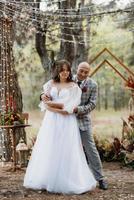 man and woman got engaged in autumn forest photo