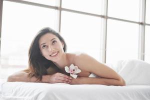 Young beautiful girl lying on a massage table. photo